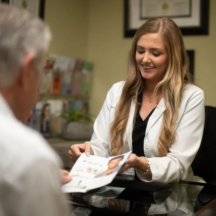 veneers-consultation-bonita-springs Dentist reviewing cosmetic smile options with a patient during a veneers consultation in Bonita Springs.